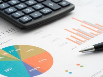 Analysis of business reports, pen and calculator on the table