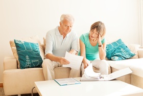 Senior couple overwhelmed with paperwork