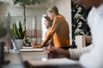 Female business people working at table in office