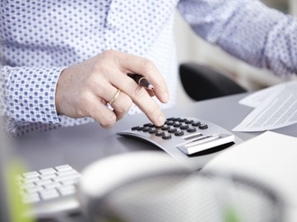 Businessman using calculator