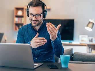 Handsome businessman having Video Conference at home