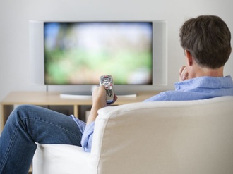 Jersey City, New Jersey, Man watching tv in living room